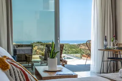a living room with a view of the ocean at Evora Suites in Chania Town