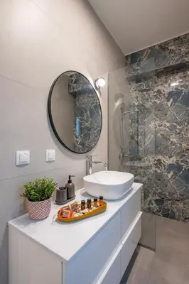 a bathroom with a sink and a mirror at Evora Suites in Chania Town