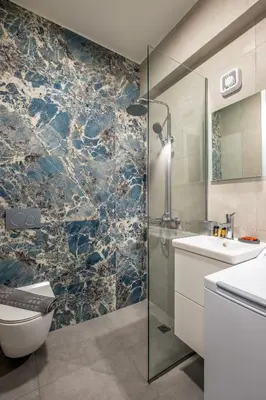a bathroom with a shower and a toilet and a sink at Evora Suites in Chania Town