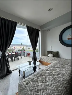 a bedroom with a bed and a view of a patio at Nova Marine in Souda