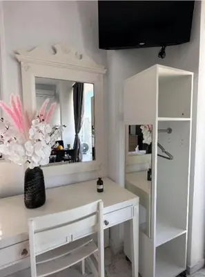 a dressing room with a desk and a mirror at Nova Marine in Souda