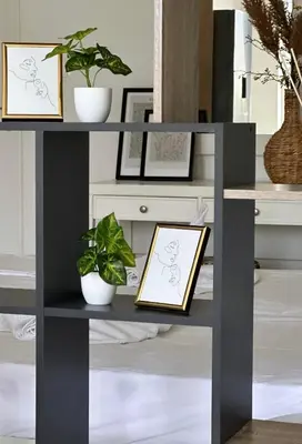 a black console table with two plants on it at Nova Marine in Souda