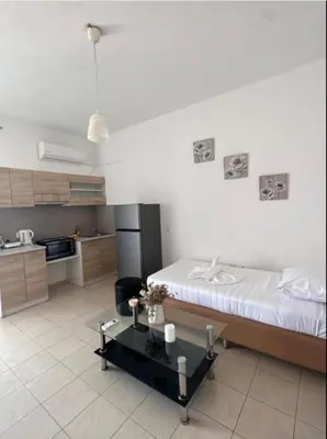 a kitchen with a bed and a table in a room at Nova Marine in Souda
