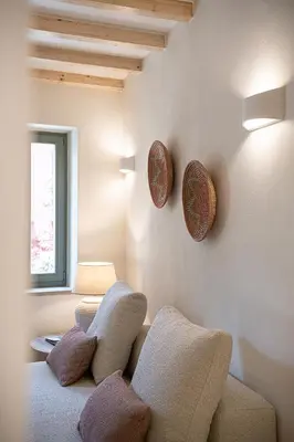 a living room with a couch and plates on the wall at Theros Home in Chania Town