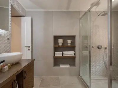 a bathroom with a shower and a sink at Theros Home in Chania Town