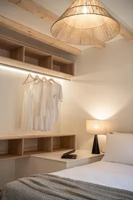 a bedroom with a bed and a lamp and a light fixture at Theros Home in Chania Town