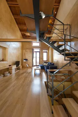 a living room with a spiral staircase in a loft at Dorotheou House in Chania Town