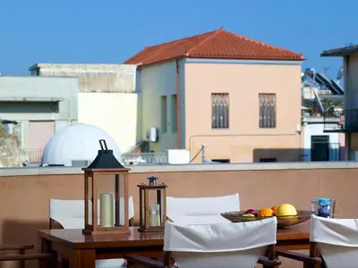 a table with a bowl of fruit on a balcony at Dorotheou House in Chania Town