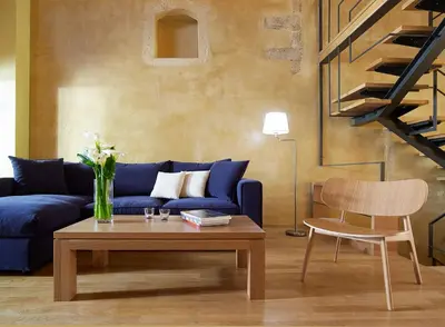 a living room with a blue couch and a table at Dorotheou House in Chania Town