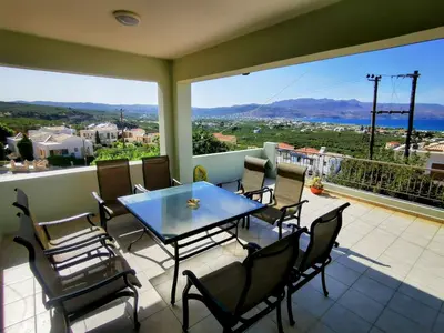 a dining room with a table and chairs on a balcony at Douranakis house Seaview Apartment in Chania Town