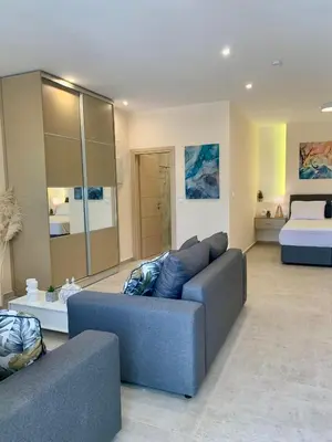 a living room with a couch and a bed at Paleochora Beach Studio (BRAND NEW) in Palaiochóra