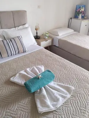 a bedroom with two towels on a bed at Notos Rooms in Loutro
