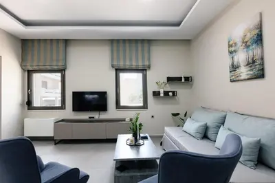 a living room with a couch and a tv at Estia Comfort House in Chania Town