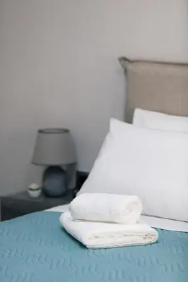 a bed with two towels sitting on top of it at Estia Comfort House in Chania Town