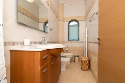 a bathroom with a sink and a toilet at Marika Seaside Villa in Yialós