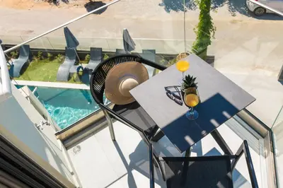 a table with a hat and a drink on it at Elia Agia Marina Resort in Agia Marina Nea Kydonias
