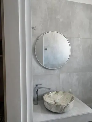 a bathroom with a stone sink and a mirror at Villa Katerina in Chania Town