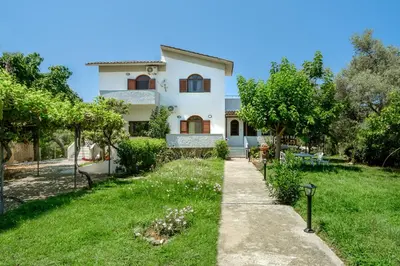 a house with a garden in front of it at Villa Thalia Chania in Chania Town