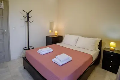 a bedroom with a bed with two towels on it at Villa Thalia Chania in Chania Town