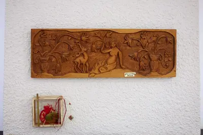 a wooden carving on a wall with a mirror at Villa Thalia Chania in Chania Town