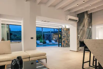 a living room with a couch and a fireplace at Casa del Balo in Gavalomoúrion