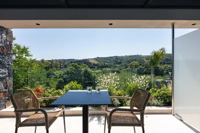 a blue table and chairs on a patio with a view at Casa del Balo in Gavalomoúrion