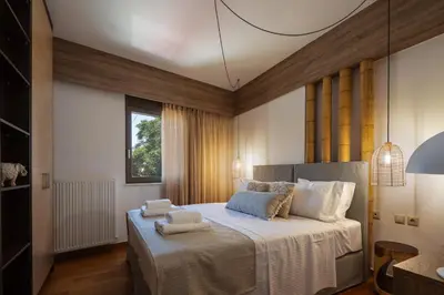 a bedroom with a large bed with towels on it at JW luxury apartment in Chania Town