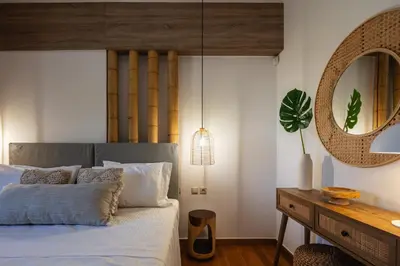 a bedroom with a bed with a mirror and a table at JW luxury apartment in Chania Town