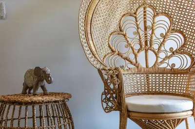 an elephant statue sitting on a stool next to a chair at JW luxury apartment in Chania Town