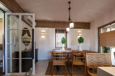 a dining room with a wooden table and chairs at JW luxury apartment in Chania Town