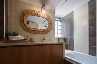 a bathroom with a sink and a mirror at JW luxury apartment in Chania Town