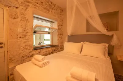 a bedroom with a bed with towels on it at Mourelo Home in Gavalochori