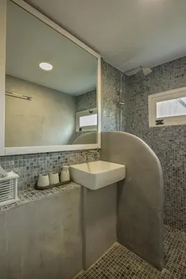 a bathroom with a sink and a mirror and a tub at Mourelo Home in Gavalochori