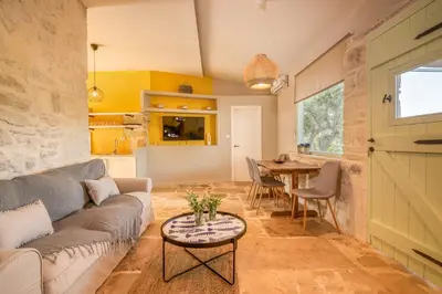 a living room with a couch and a table at Mourelo Home in Gavalochori