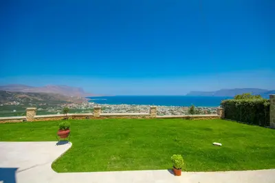 a green lawn with a view of the ocean at Korfali Apartments in Kissamos