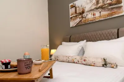 a bedroom with a bed with a table with a tray of food at Seaside Escape in Nopíyia