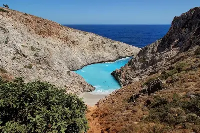 a view of a beach in a canyon with blue water at Seaside Escape in Nopíyia