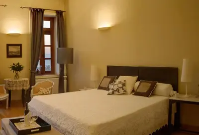 a bedroom with a bed with white sheets and a window at Dorothy's Dream in Chania Town