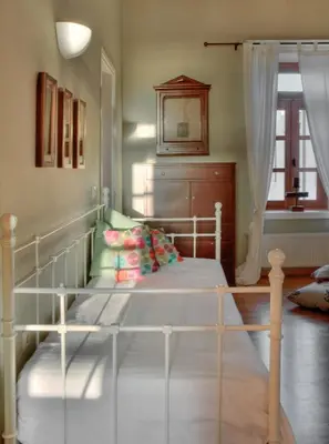 a white bed in a room with a window at Dorothy's Dream in Chania Town