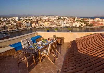 a table and chairs on a balcony with a view at Dorothy's Dream in Chania Town