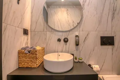 a bathroom with a white sink and a mirror at Nusa Retreat - Seaview luxury residences - ideal for groups in Kissamos