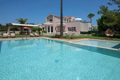 a large swimming pool in front of a house at Villa Damant in Pithárion
