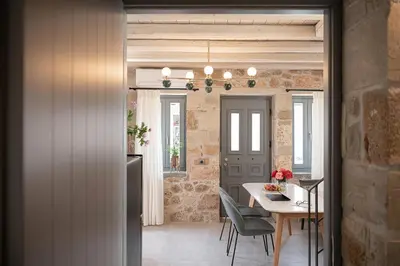 a kitchen and dining room with a table and chairs at La Canea Living in Chania Town