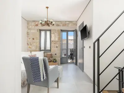 a hallway with a living room with a couch and a tv at La Canea Living in Chania Town