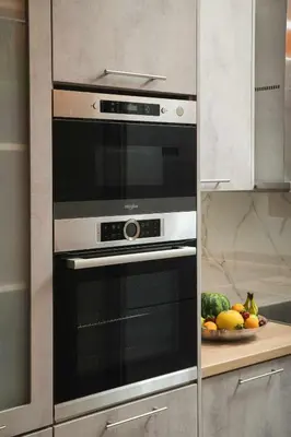 a black and silver oven in a kitchen with a plate of fruit at Somine Apartment Chania in Chania Town