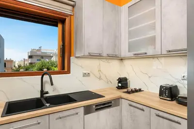 a kitchen with a sink and a window at Somine Apartment Chania in Chania Town