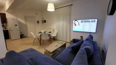 a living room with a blue couch and a table at Villa Alex in Tavronitis