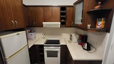 a small kitchen with a stove and a refrigerator at Villa Alex in Tavronitis