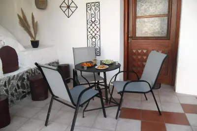 a table with four chairs and a plate of food on it at Anastasia Country Home in Strovlés