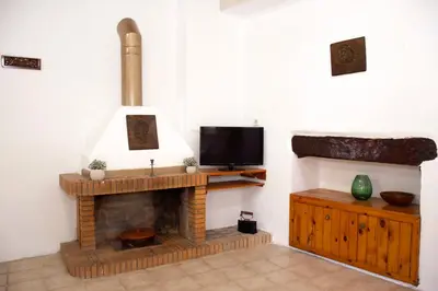 a living room with a fireplace and a tv at Anastasia Country Home in Strovlés